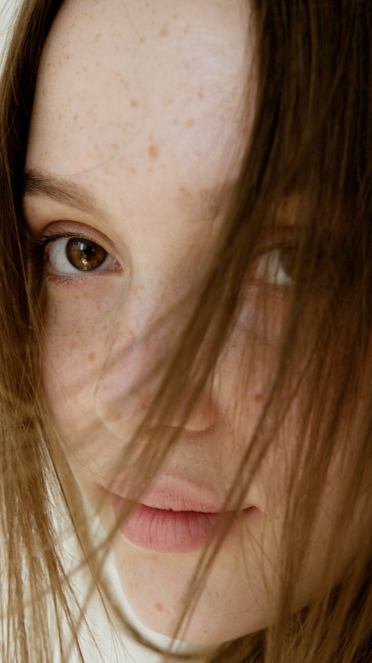 a woman freckled face in close up shot
