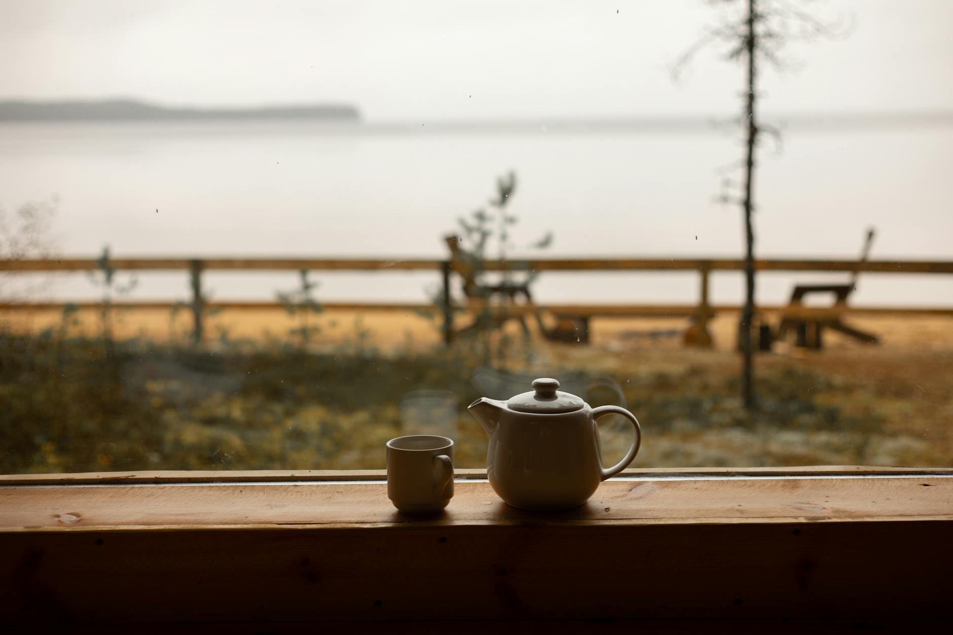 white ceramic tea kettle and a cup